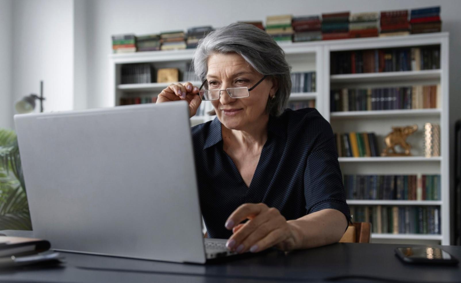 Financial planning workspace with laptop and budget worksheets